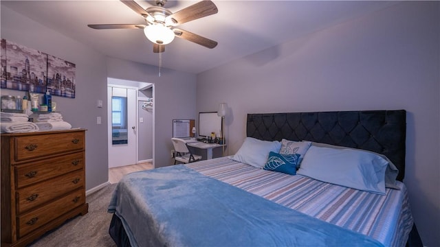 bedroom with a ceiling fan, carpet, and baseboards