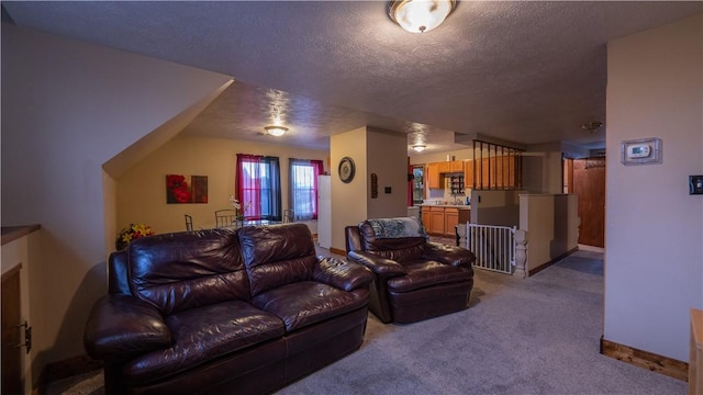 carpeted living room with a textured ceiling and baseboards