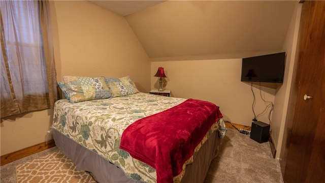 bedroom with carpet floors, vaulted ceiling, and baseboards