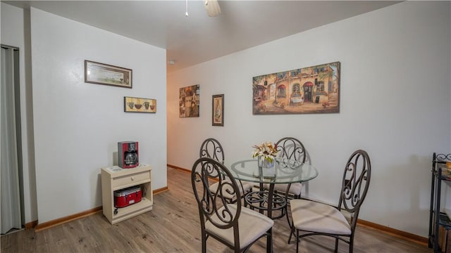 dining room featuring baseboards and wood finished floors