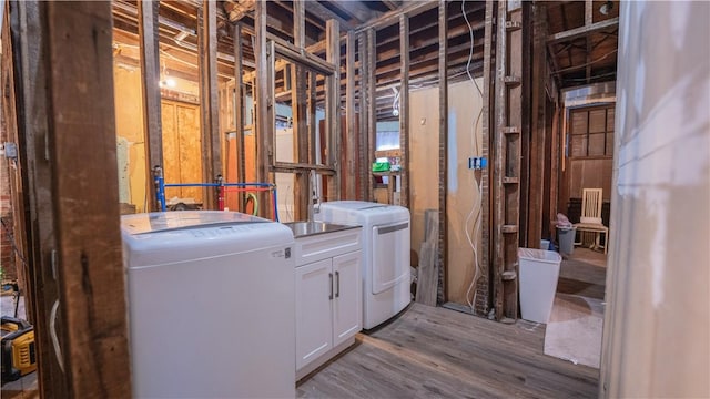 interior space with washer and dryer and wood finished floors