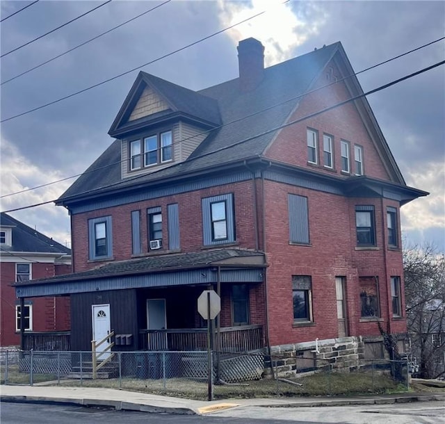 241 Locust Ave, City Of Washington, PA 15301 - view of front facade with a fenced front yard, covered porch, brick siding, and a chimney