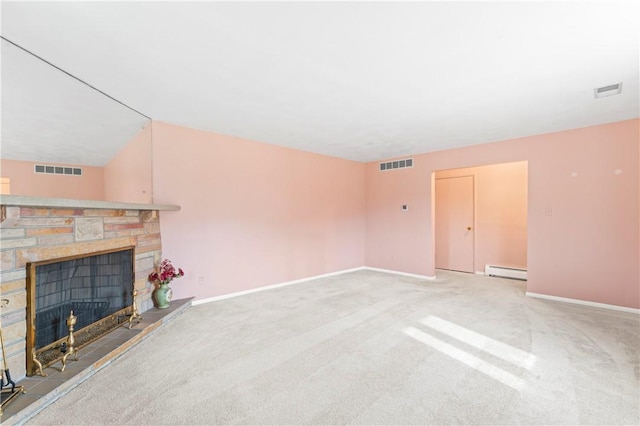 unfurnished living room with a stone fireplace, a baseboard radiator, and light colored carpet