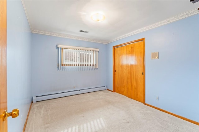 carpeted empty room with a baseboard radiator