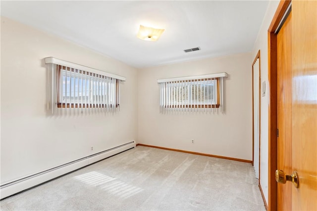 unfurnished room featuring a baseboard radiator and light carpet