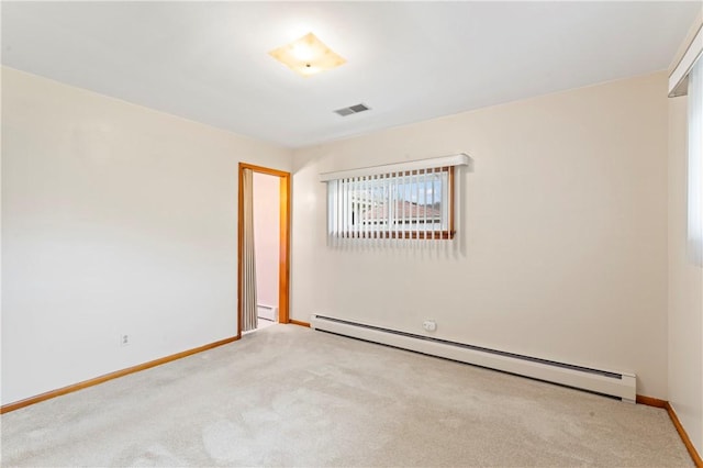 carpeted spare room with baseboard heating