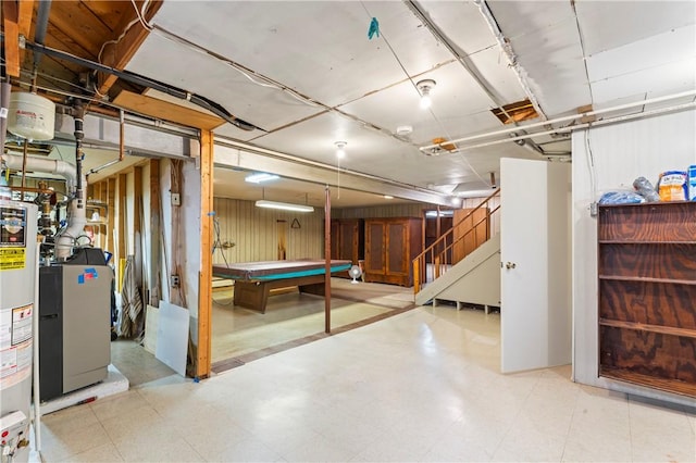 basement featuring pool table and water heater