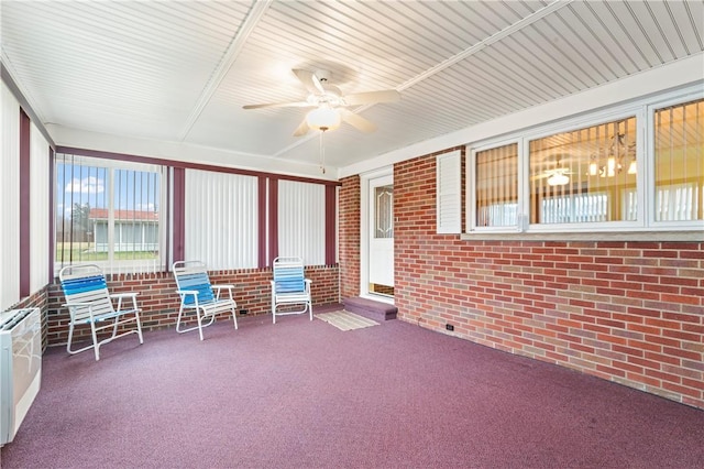 unfurnished sunroom featuring ceiling fan