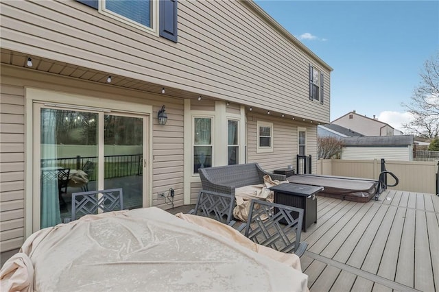 deck with a covered hot tub