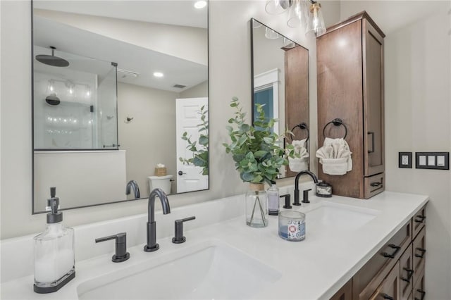 bathroom with walk in shower and vanity