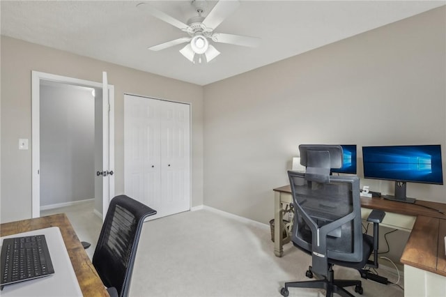 carpeted home office with ceiling fan