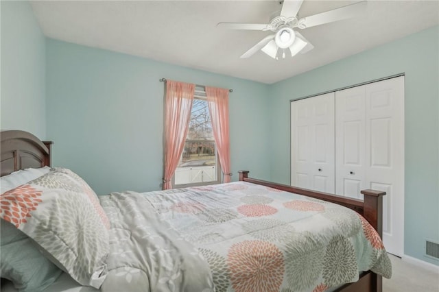 carpeted bedroom with a closet and ceiling fan