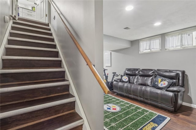 staircase with hardwood / wood-style flooring