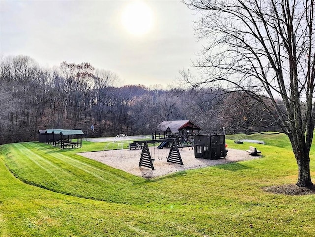 view of property's community with a playground and a yard