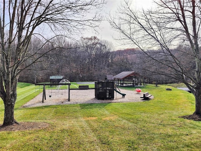 view of property's community with a playground and a lawn