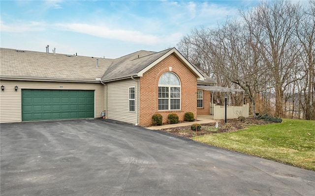 ranch-style home with a garage and a front yard