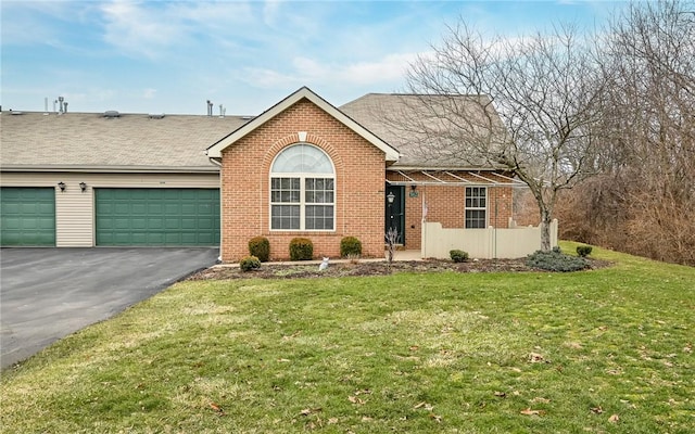 ranch-style house featuring a garage and a front lawn