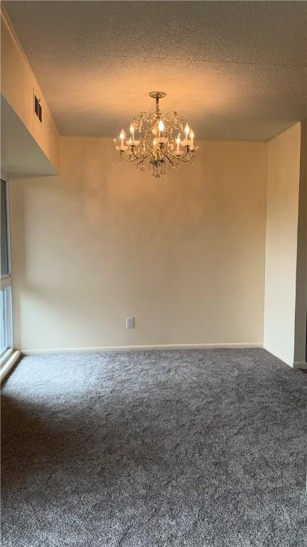 4402 Charlemagne Cir, Ross Twp, PA 15237 - carpeted empty room with a chandelier, a textured ceiling, and baseboards