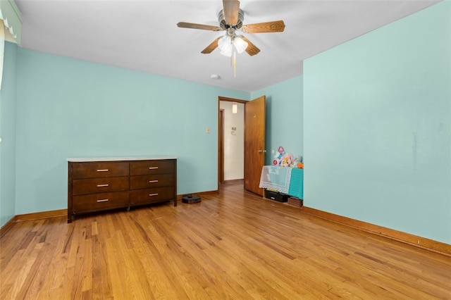 unfurnished bedroom featuring ceiling fan, baseboards, and light wood-style floors