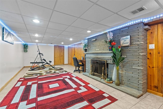 playroom with baseboards, a fireplace, visible vents, and a paneled ceiling