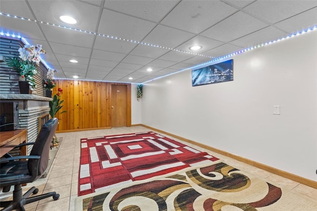 interior space with recessed lighting, baseboards, a paneled ceiling, and light tile patterned floors