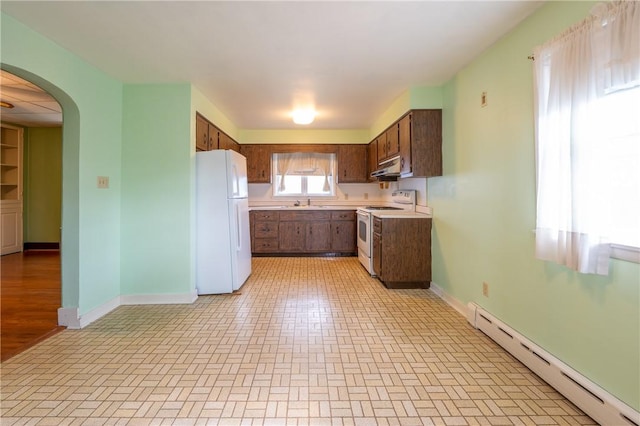 kitchen featuring white appliances and a baseboard radiator