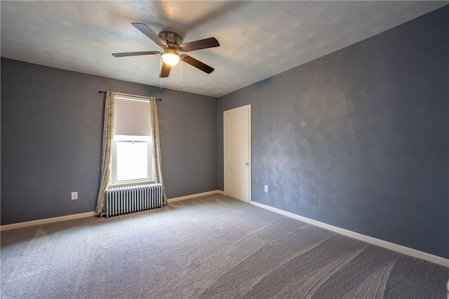 empty room with ceiling fan, radiator heating unit, and carpet