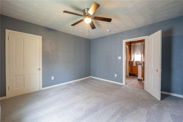 unfurnished bedroom featuring ceiling fan and carpet