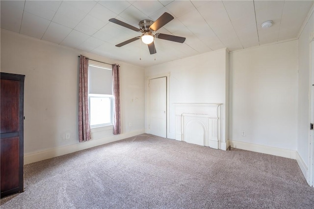 unfurnished room featuring ornamental molding, ceiling fan, and carpet