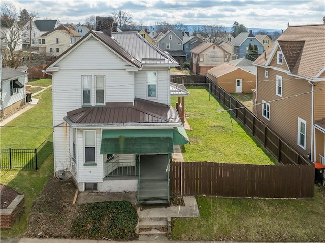 rear view of house with a lawn