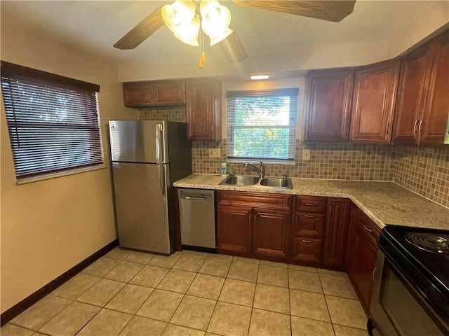 kitchen featuring stainless steel appliances, sink, light tile patterned floors, and decorative backsplash