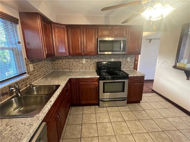 kitchen featuring stainless steel appliances, tasteful backsplash, sink, and light tile patterned floors