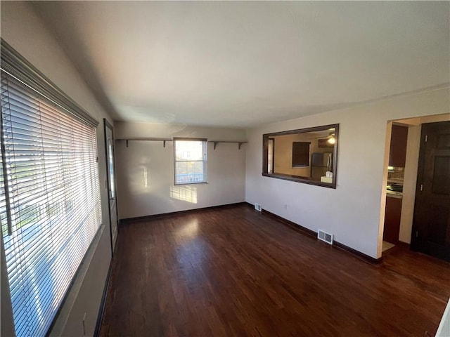 empty room with dark wood-type flooring