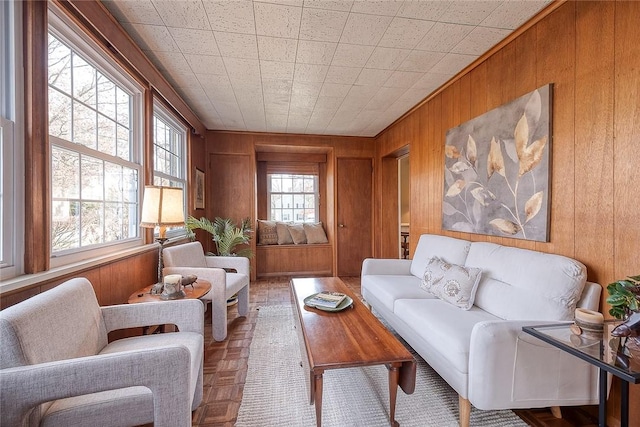 sitting room with parquet floors and wood walls