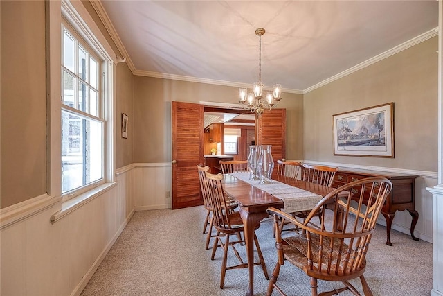 carpeted dining space with ornamental molding and a notable chandelier