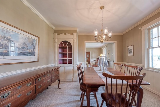 dining room featuring ornamental molding, light colored carpet, and a notable chandelier