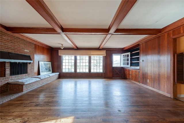 unfurnished living room with dark hardwood / wood-style flooring, wooden walls, coffered ceiling, and beamed ceiling