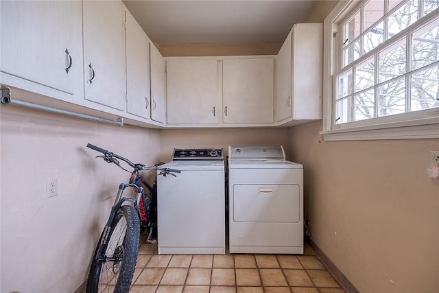 laundry room with cabinets and washing machine and clothes dryer