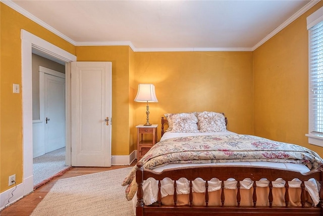 bedroom with multiple windows, crown molding, and light hardwood / wood-style floors