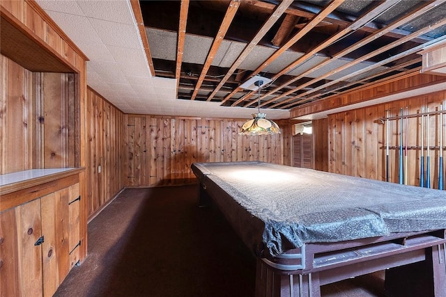 playroom featuring dark carpet and wooden walls