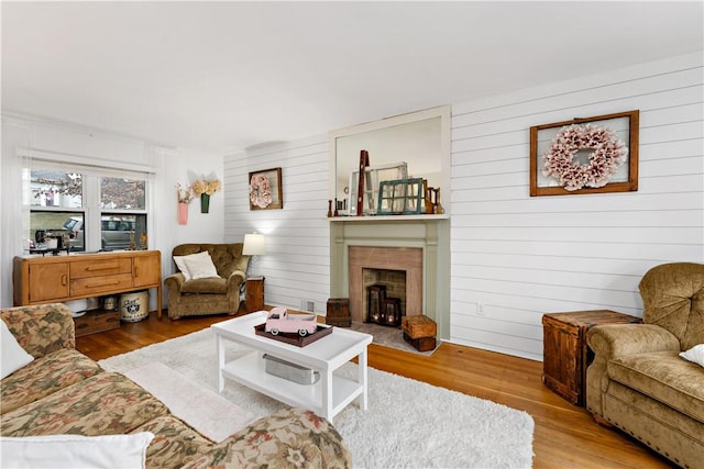 living room featuring a fireplace and light wood-type flooring