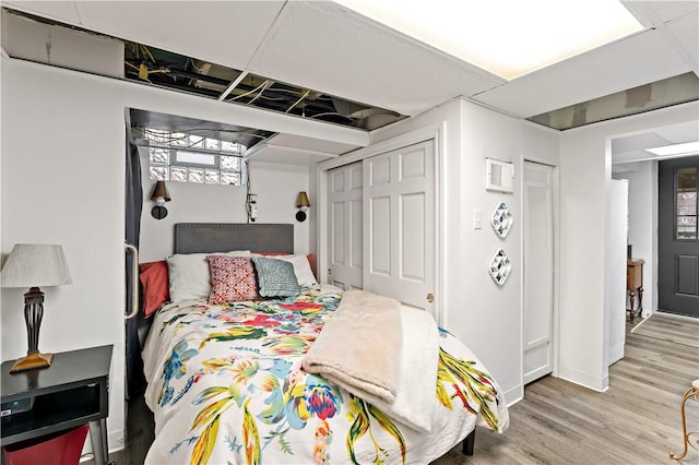 bedroom with hardwood / wood-style floors and a closet