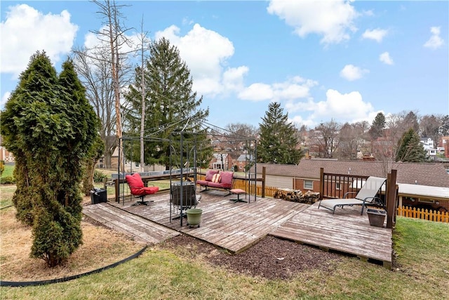 deck with outdoor lounge area and a lawn