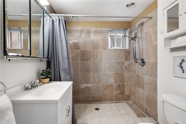 bathroom with vanity, toilet, and walk in shower