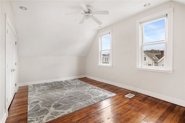 bonus room with vaulted ceiling, dark hardwood / wood-style floors, and ceiling fan