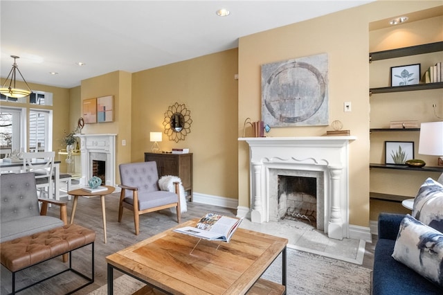 living room with hardwood / wood-style flooring and a high end fireplace