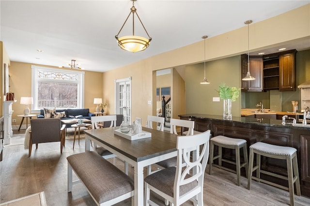 dining area featuring sink and wood-type flooring