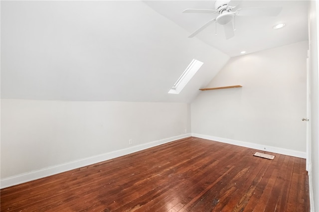 bonus room with hardwood / wood-style floors, lofted ceiling with skylight, and ceiling fan