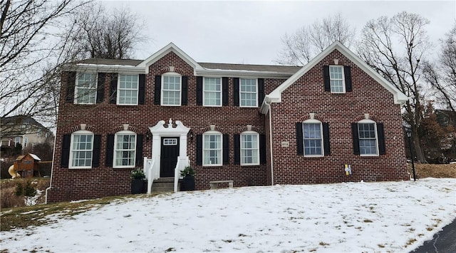 colonial home with brick siding