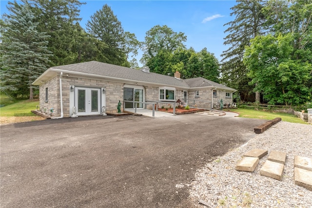 back of property with french doors and a patio